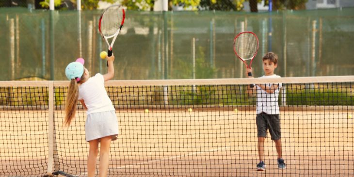 kids playing tennis on a tennis court