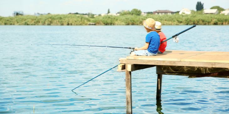 children fishing on a dock